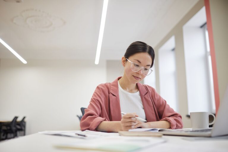 woman reviewing document to prepare for a meeting